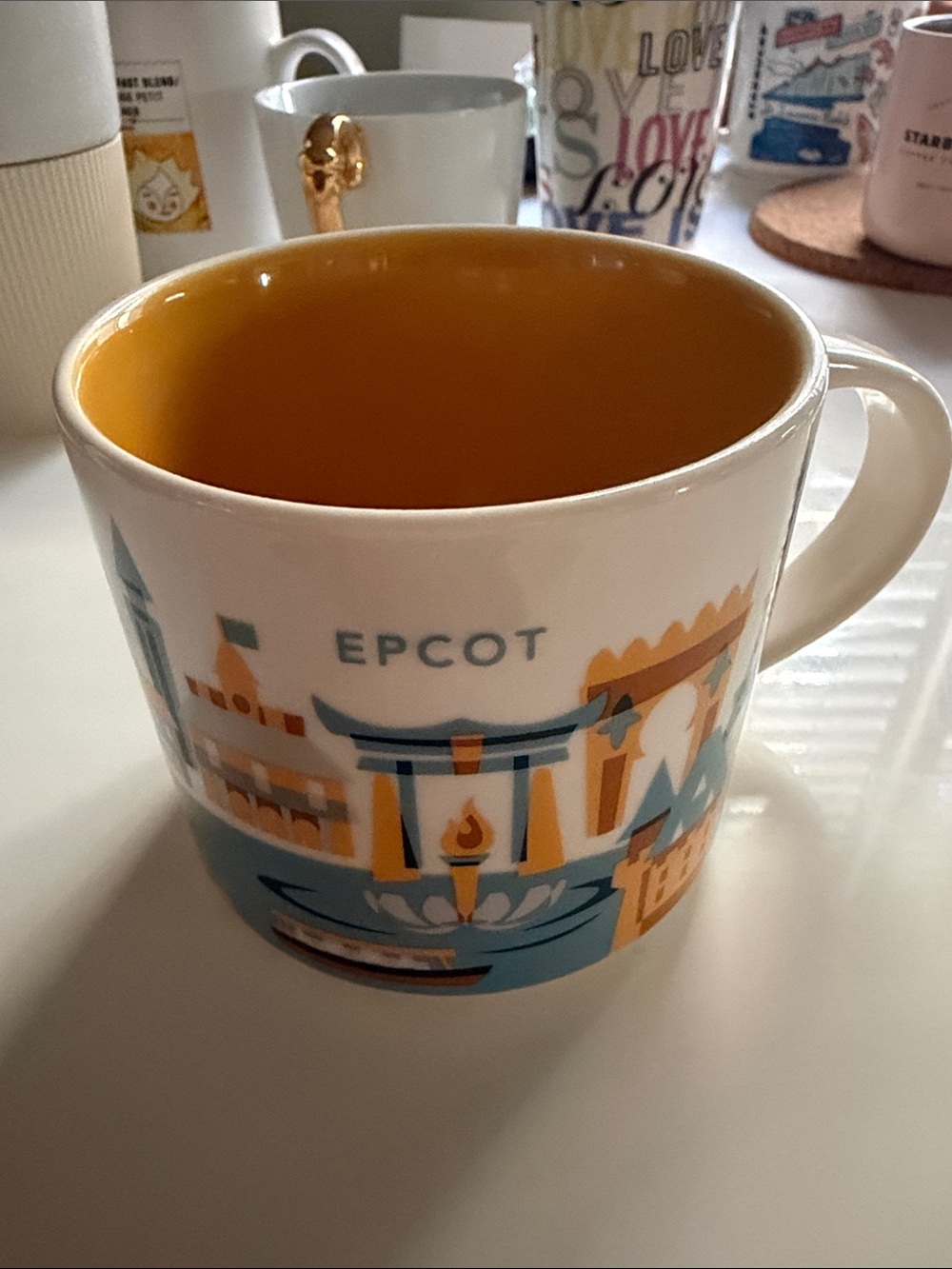 Starbucks EPCOT Ceramic Mug with Yellow Interior and Blue-Tan Graphics